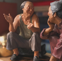 Seated Elderly Couple Figurines - Pair